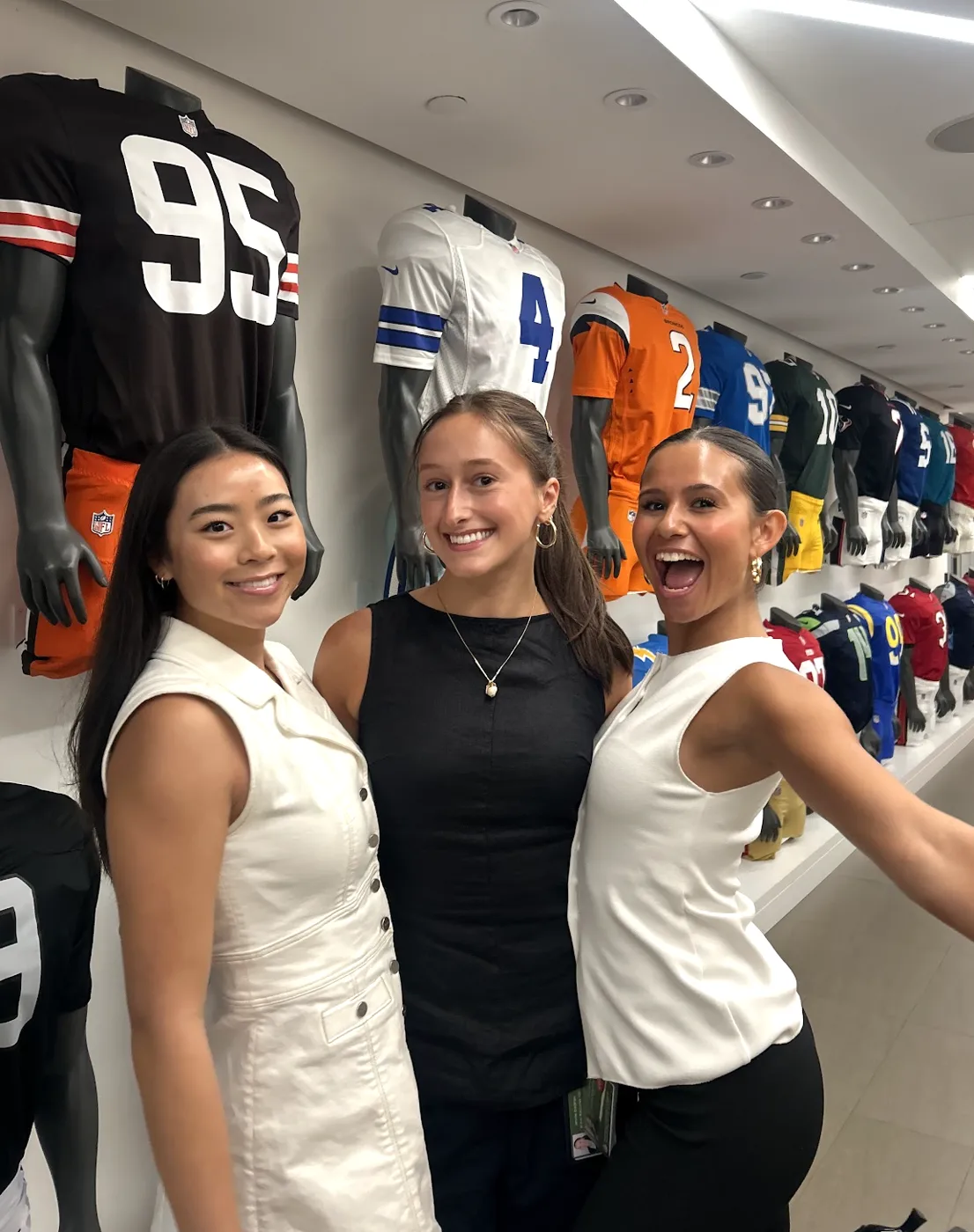 with friends by the nfl jersey wall